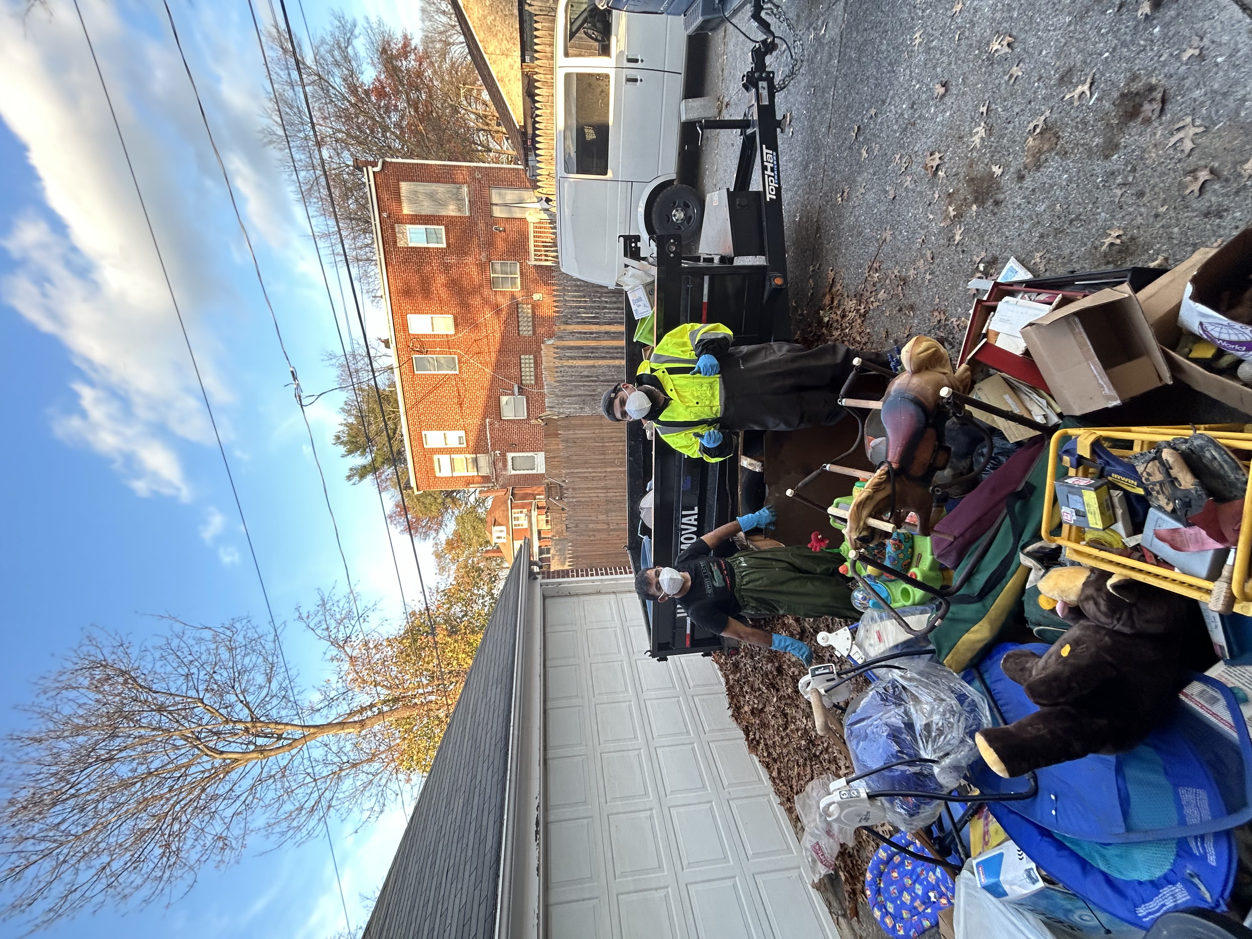 Junk Squad crew next to a large junk pile and trailer during a local cleanout in Central PA